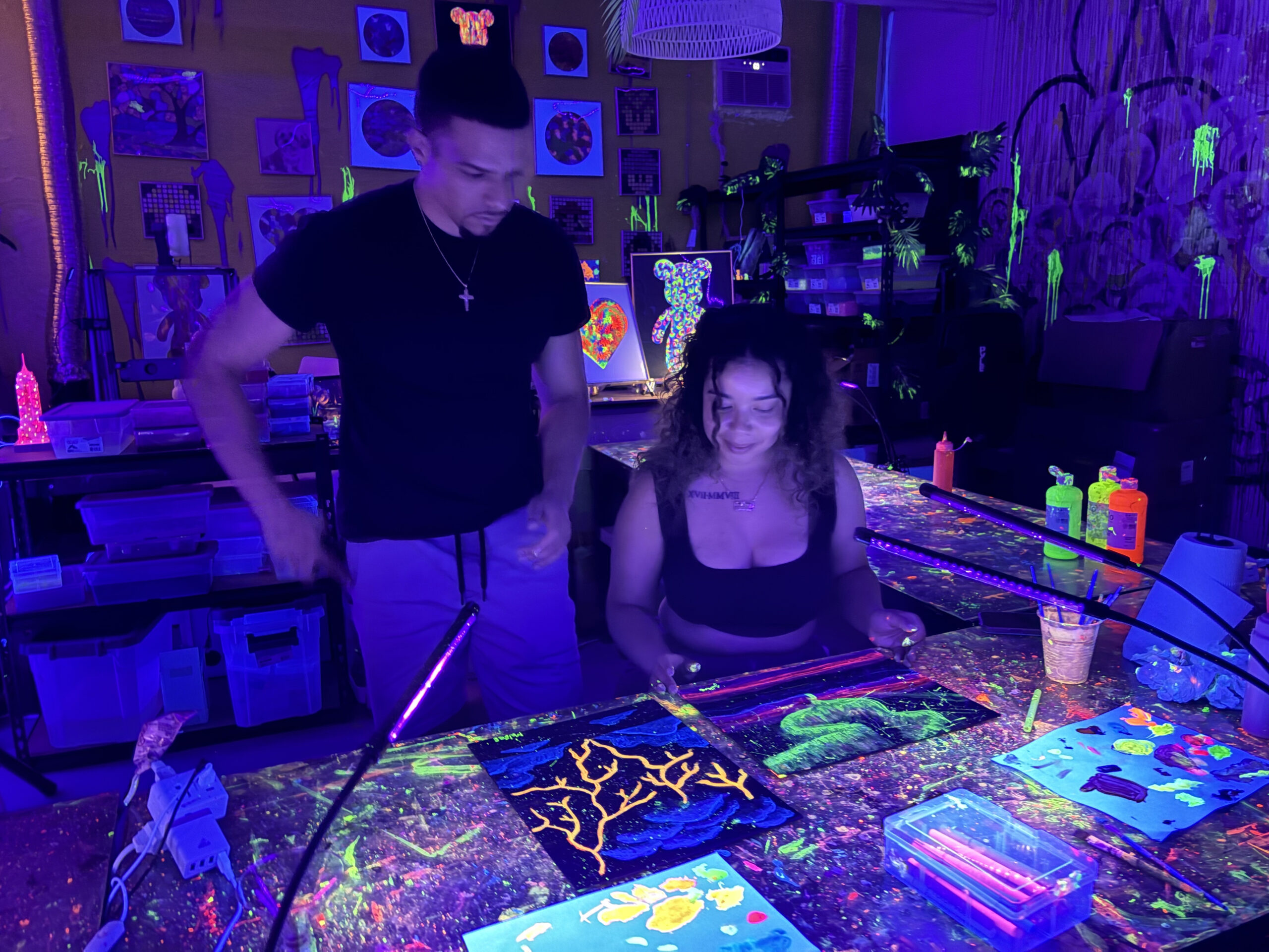 Couple with their paintings at a Cozy Art Land glow session
